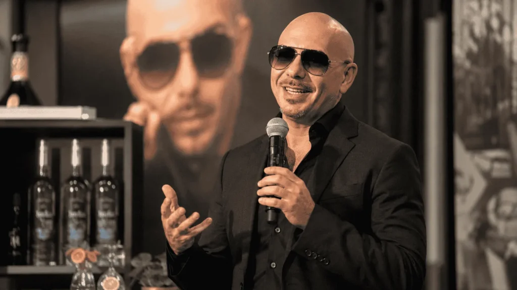 Pitbull at a brand event connected to his net worth and business income