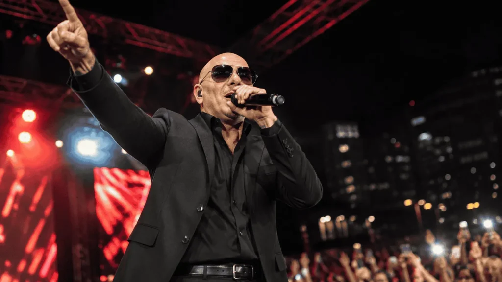 Pitbull performing live, tied to Pitbull net worth growth through touring
