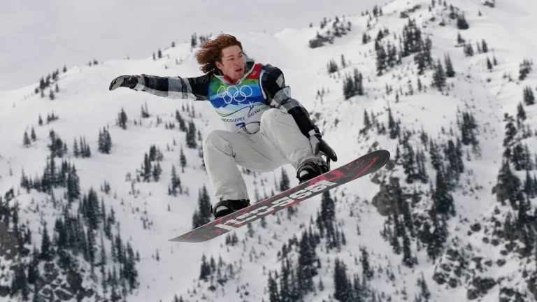 Shaun White net worth story shows him competing in an Olympic snowboard halfpipe