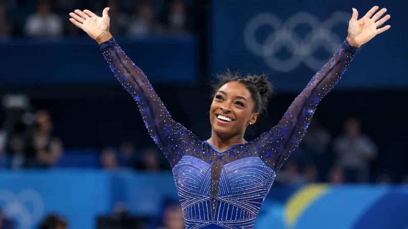 Simone Biles performing a floor routine at a gymnastics competition
